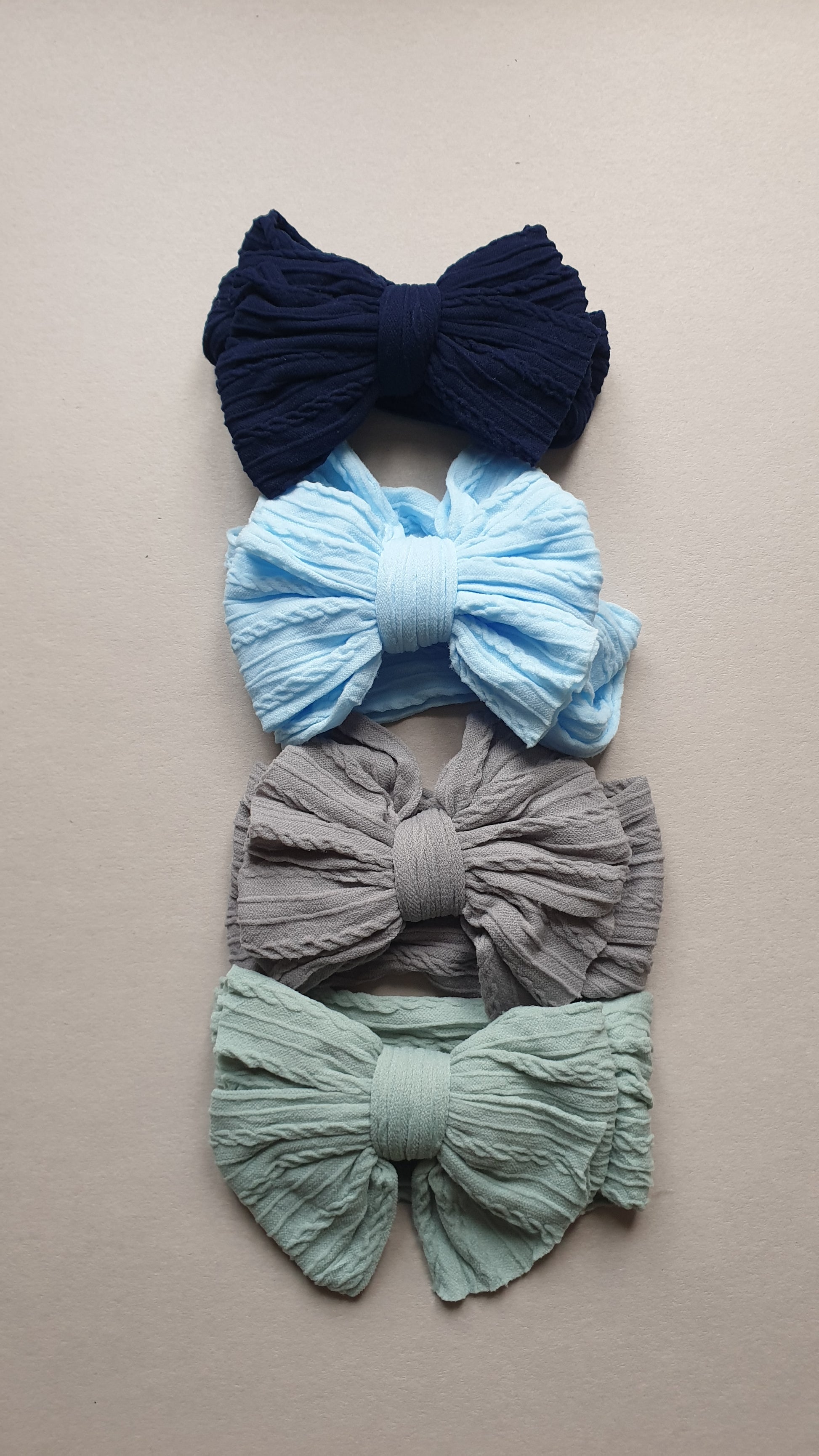 Fabric bows in navy, light blue, gray, and green colors.