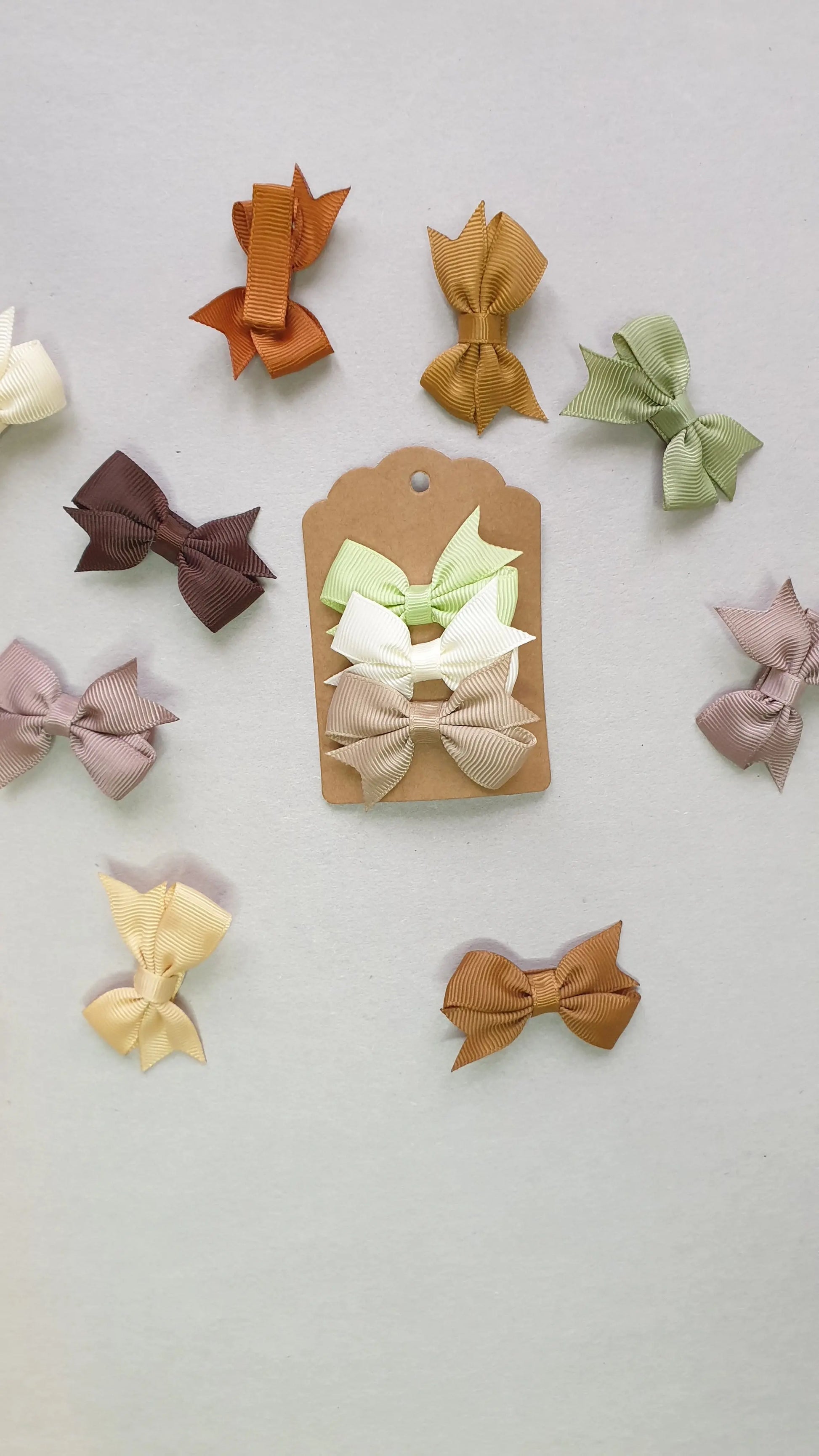 A collection of small, colorful ribbon bows in shades.