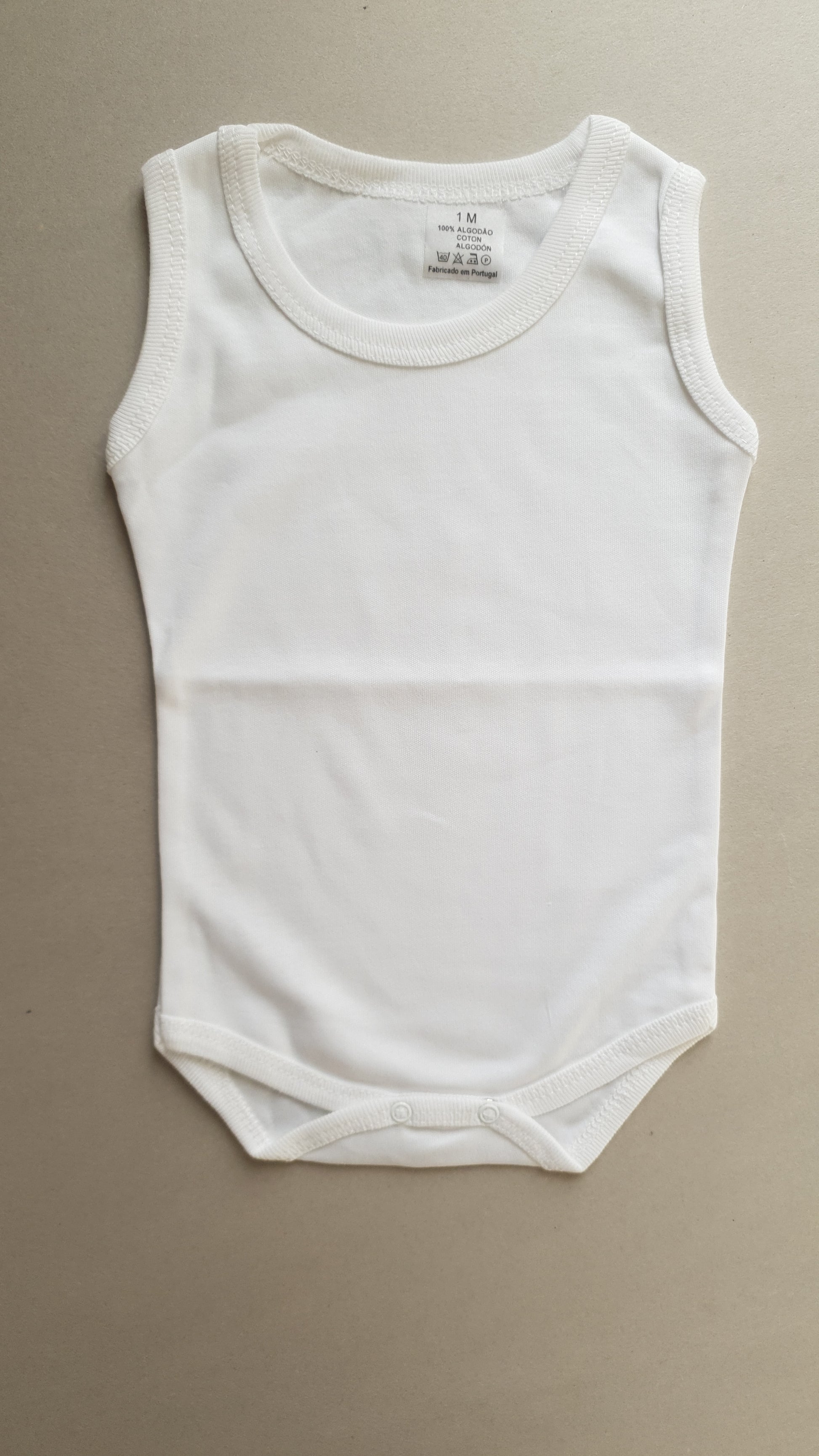 White infant onesie with sleeveless design.