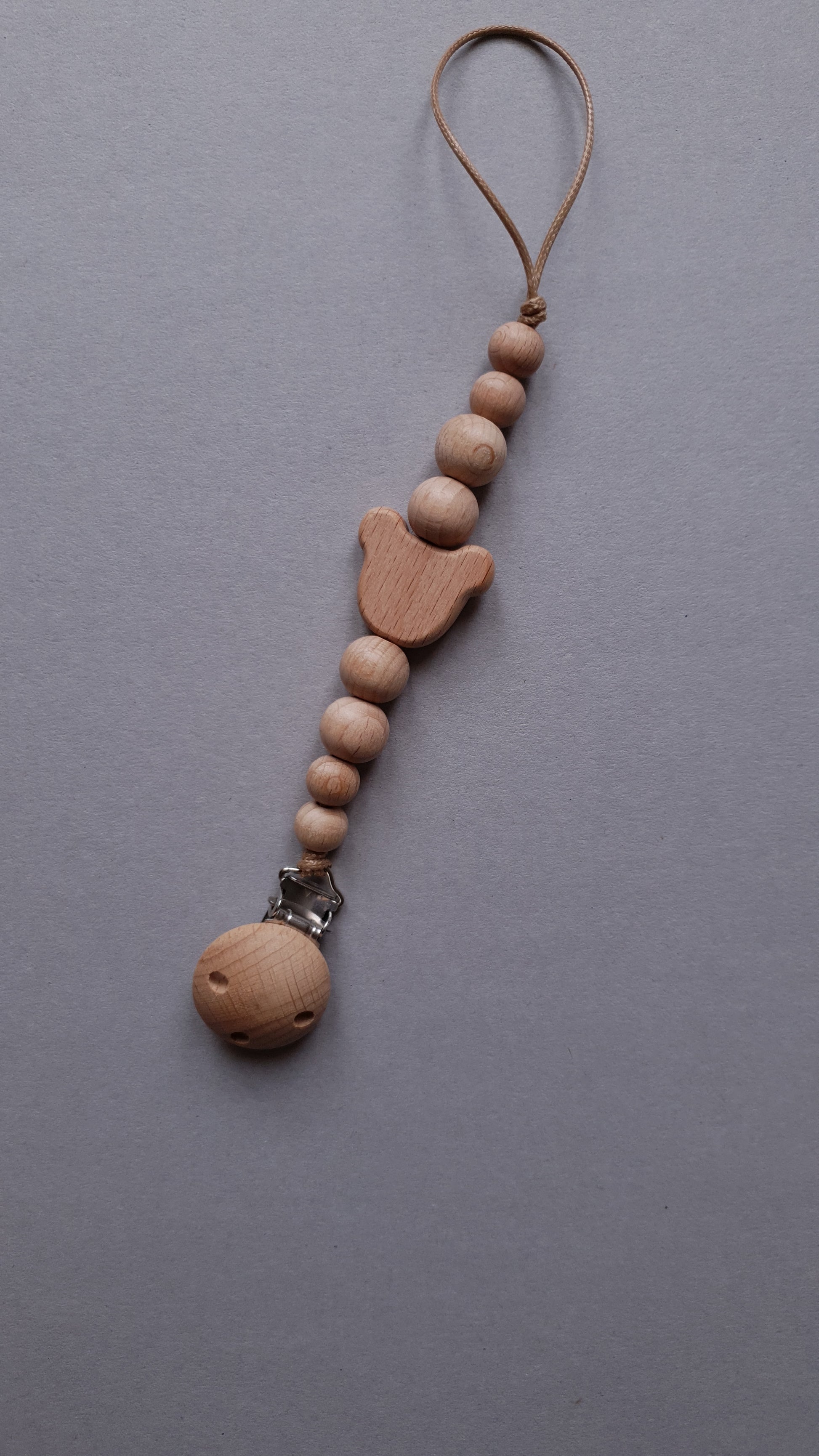 A wooden keychain with round beads, a tulip-shaped bead.