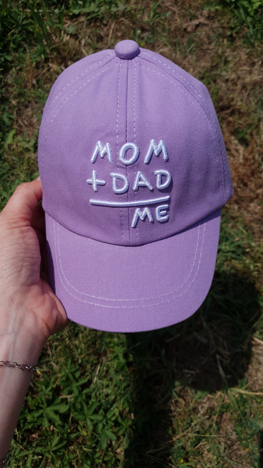 A purple baseball cap with the MOM + DAD = ME message.