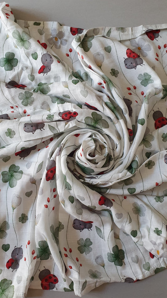 A white fabric with a spiral fold with various prints.