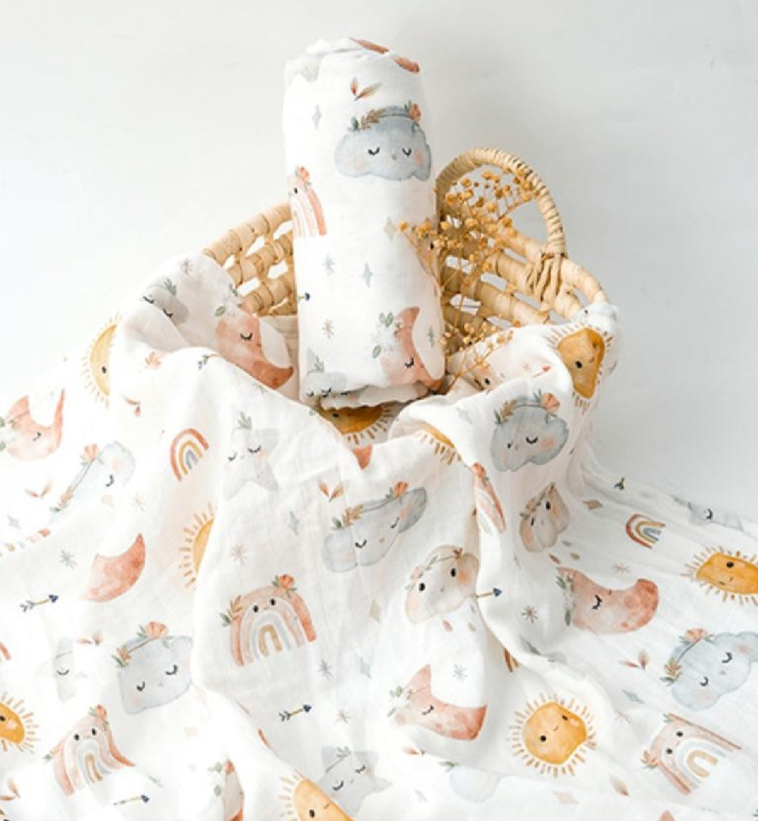 A baby blanket with sun, moon, and cloud patterns.