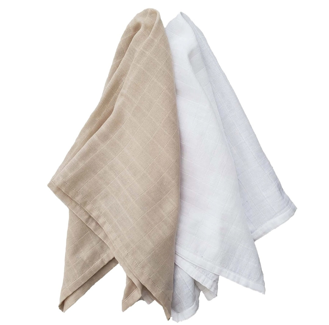 Two crumpled linen towels of beige and white colors.