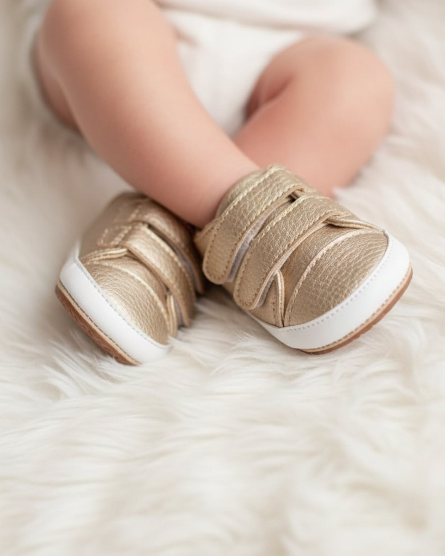 Golden toddler shoe with Velcro straps and a white sole.