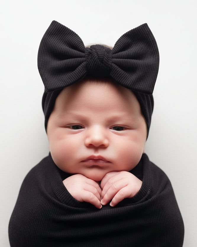 Three ribbed headbands are stacked on a light background.