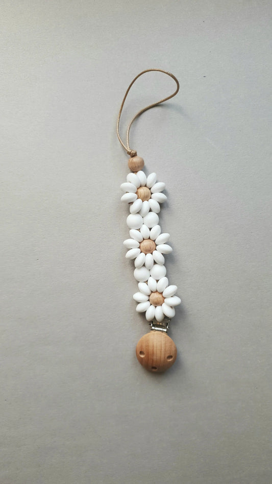 A daisy-themed pacifier clip with white flower beads.