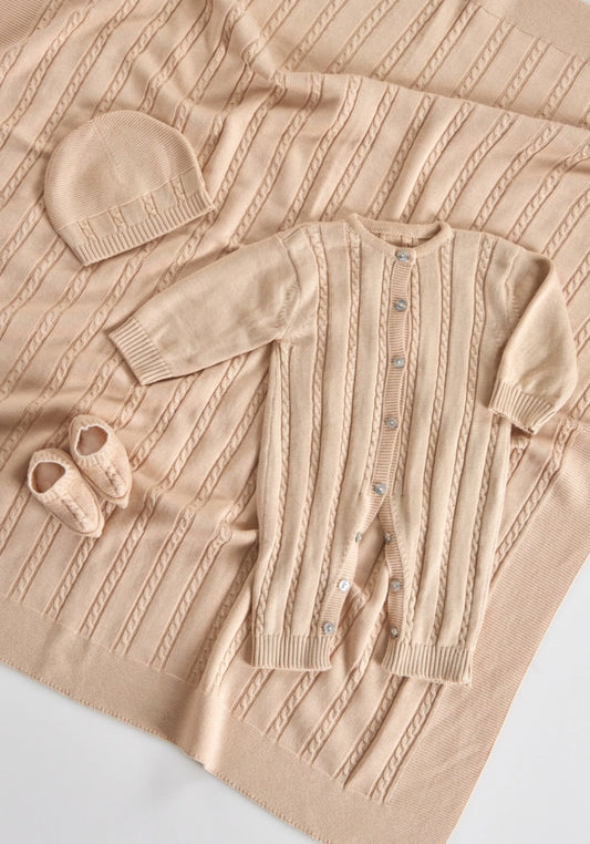 A matching beige baby set with a blanket, beanie, and onesie.